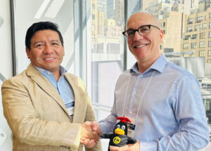 Stefano Maffulli, Executive Director at OSI (right), and Hernán Pachas, Global Head of Partnership at LPI, shaking hands in New York City.